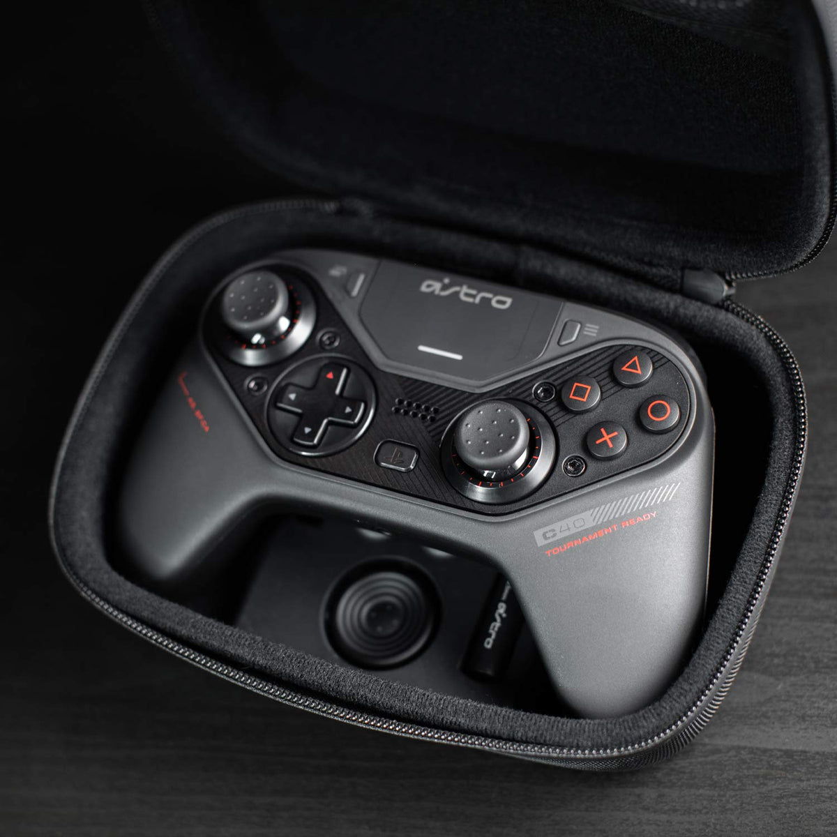 ASTRO Gaming C40 Tr Controller black with matte finish, textured grips, customizable buttons, and dual analog sticks in a carrying case.