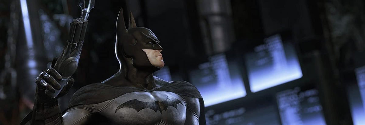 Batman action figure with black suit and cape holding a grappling gun, representing Batman: Return to Arkham video game character.