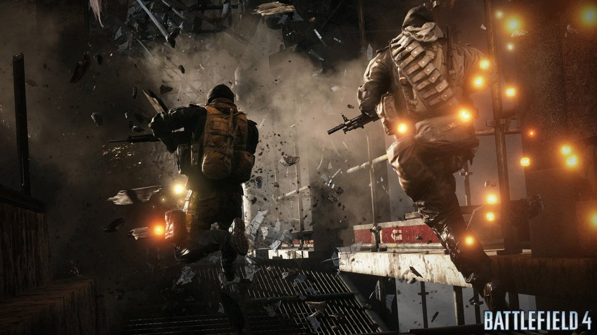 Battlefield 4 scene showing two soldiers in tan and brown tactical gear running through debris with explosions and flying shards around them.