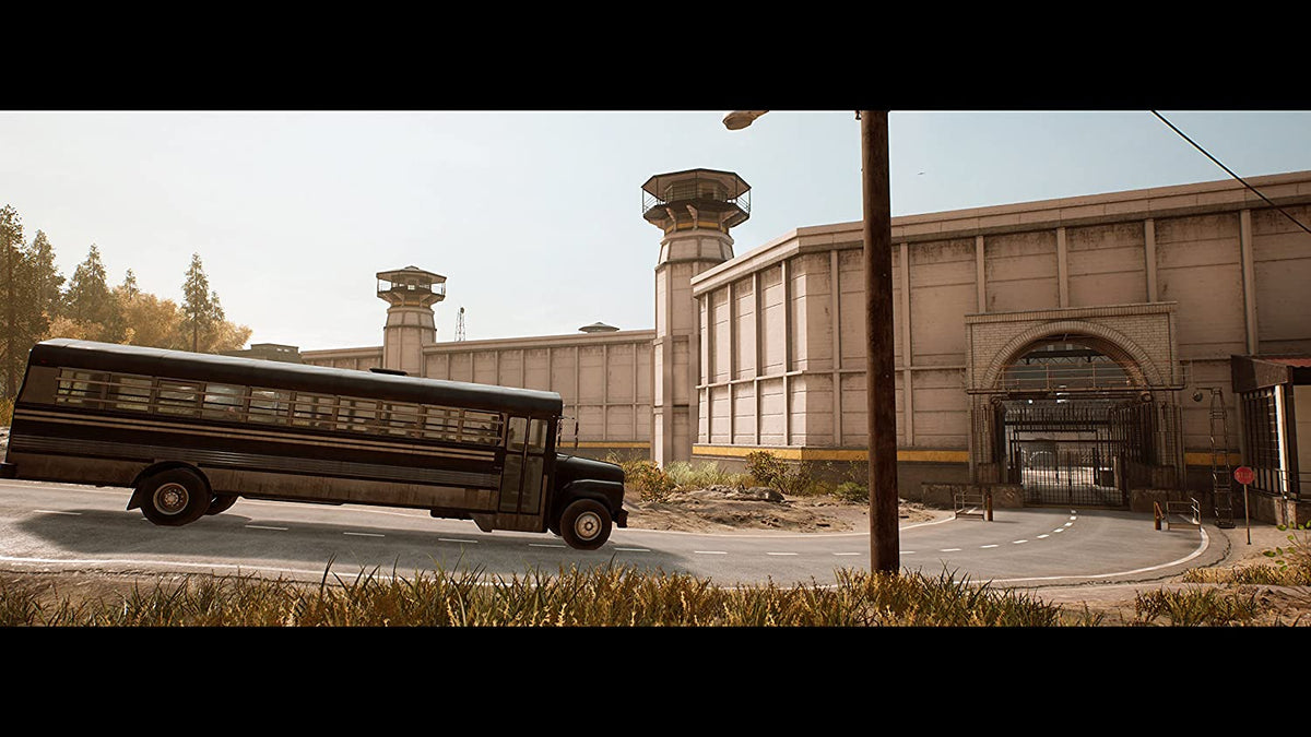 Prison bus in front of a large beige concrete prison building with watchtowers, showcasing A Way Out gameplay setting.