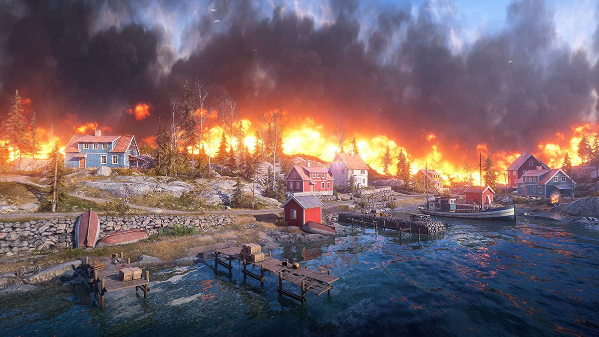 Battlefield V PS4 game scene showing a coastal village with houses and docks engulfed in flames and thick smoke.