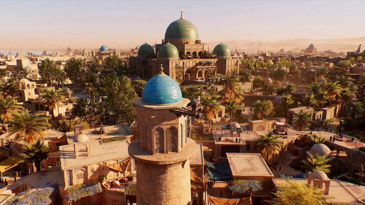 Ancient cityscape with detailed tan sandstone buildings and blue domes surrounded by lush palm trees in Assassin's Creed Mirage.